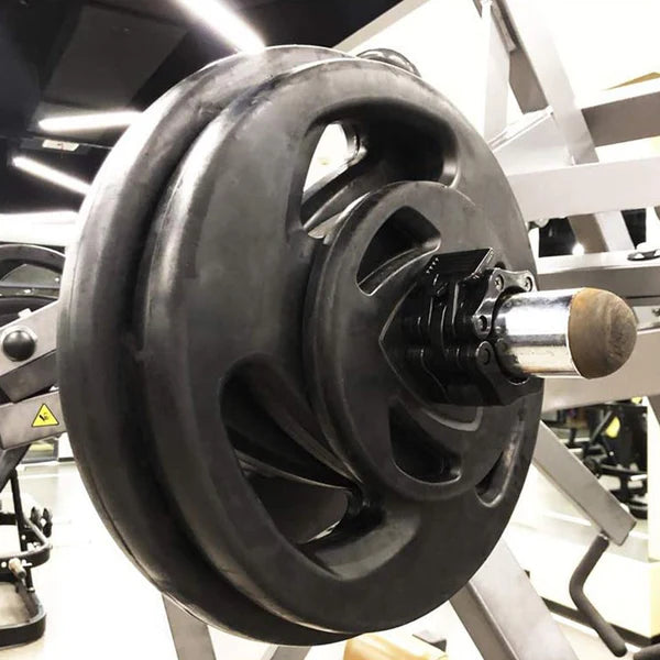 Close-up of a barbell weight plate in a gym setting