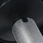 Close-up of a metal mesh filter against a dark background