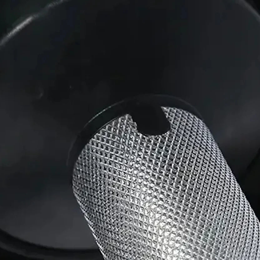Close-up of a metal mesh filter against a dark background