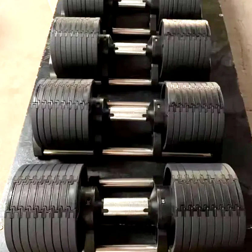 Close-up of a row of black metal dumbbells with textured grips.