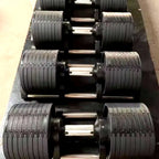 Close-up of a row of black metal dumbbells with textured grips.