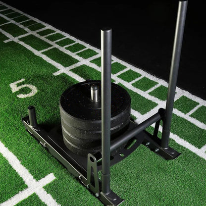 Weight plate on a stand on a football field