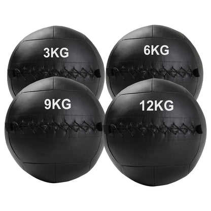 Four black medicine balls with weight markings on a white background