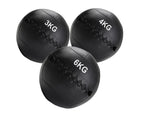 Three black weighted medicine balls with weight markings on a white background